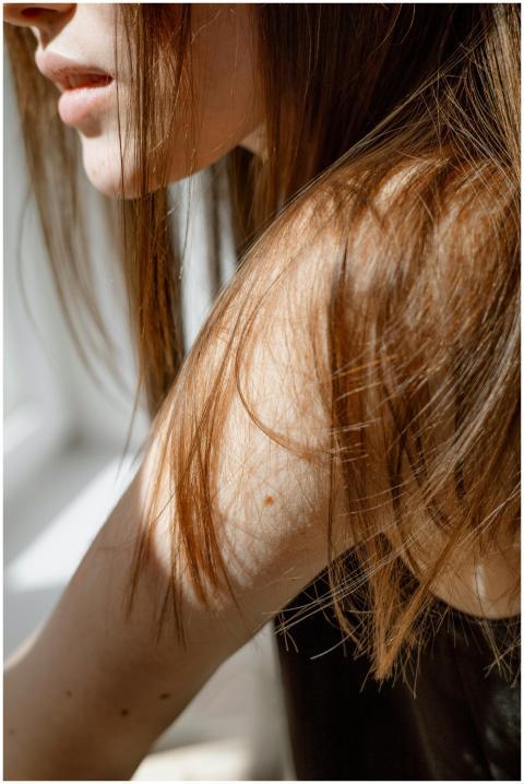 Artistic close-up of a woman's arm and hair in nat