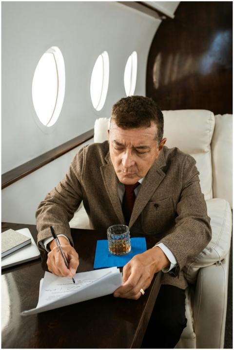 Professional businessman signing documents on a lu
