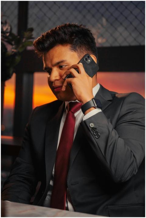 Professional man in a suit making a phone call wit