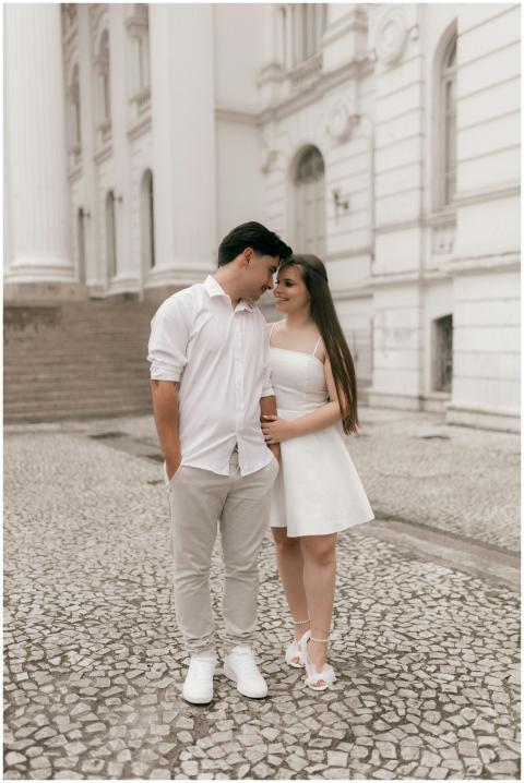 A young couple embraces lovingly in front of a his