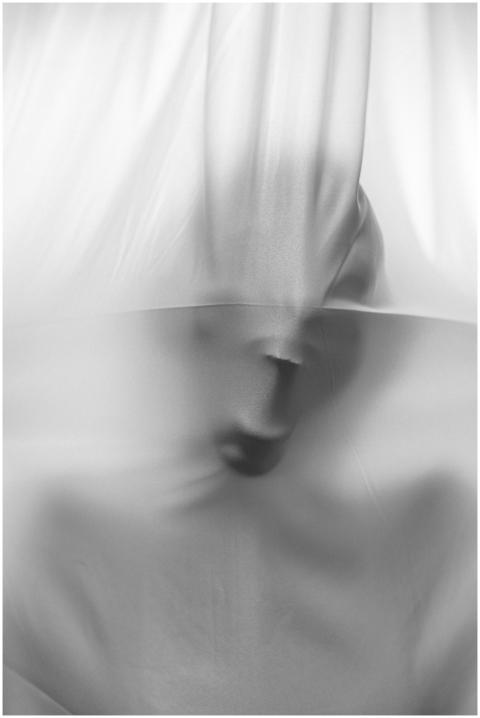 Abstract image of a face pressing against fabric,
