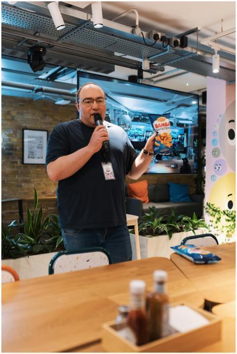 Man with microphone showcasing snack product in mo
