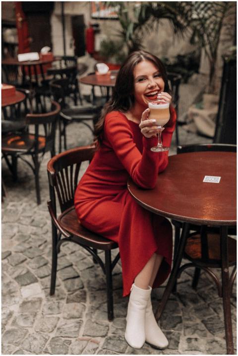 Smiling woman in red dress enjoying a sophisticate
