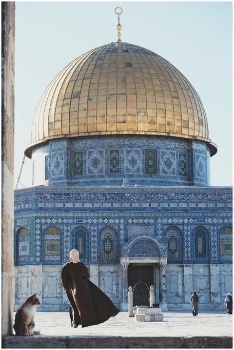 A woman observes the Dome of the Rock in Jerusalem