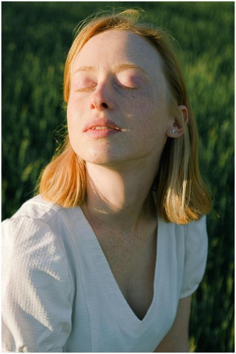 Tranquil portrait of a woman enjoying the sunlight