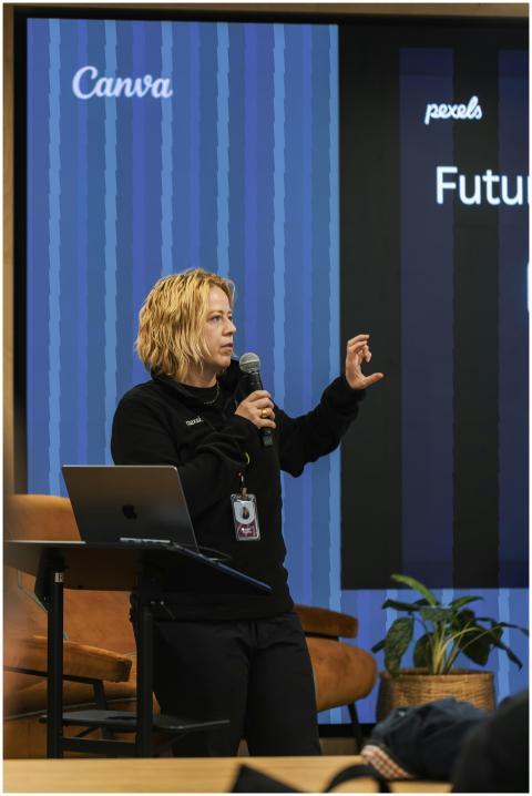 Speaker presenting at a tech conference, engaging