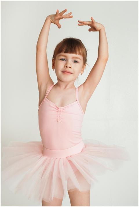 Charming portrait of a young ballerina in a pink t