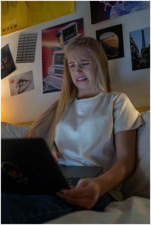 Teen girl reacts to unpleasant online content on a