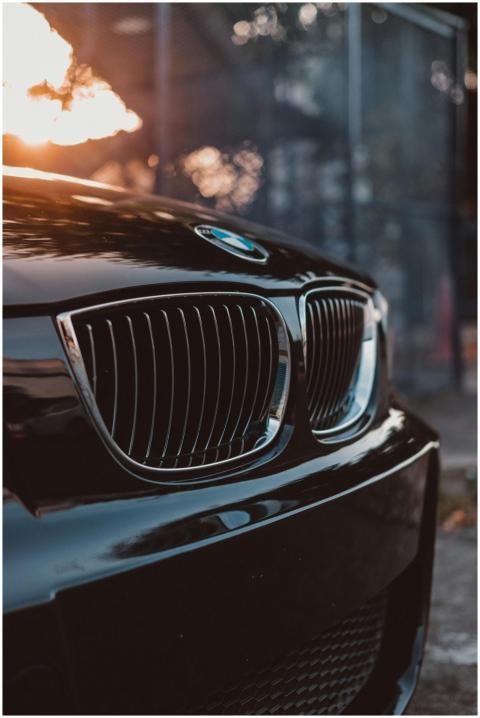 Stylish luxury car grille in focus with sunset ref