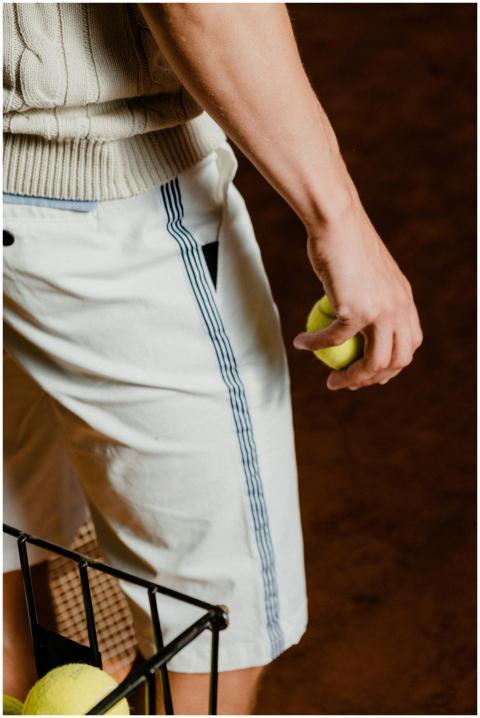 Focused shot of a tennis player holding a ball, re
