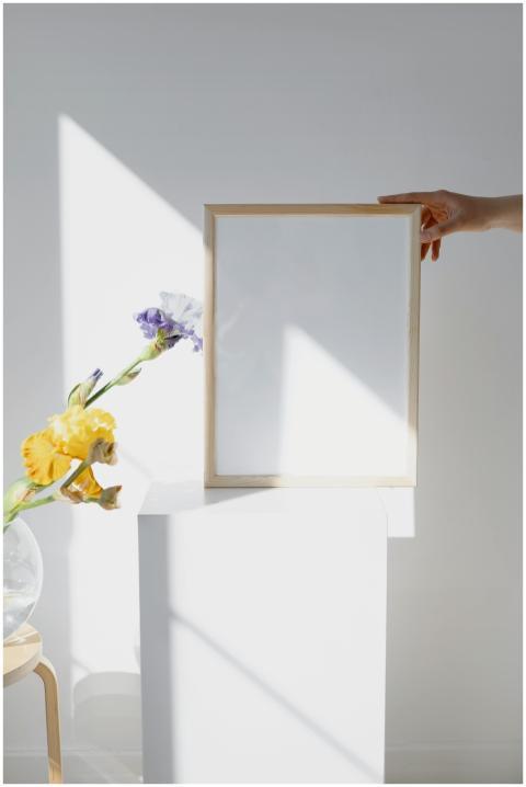 A minimalist mockup featuring a wooden frame held