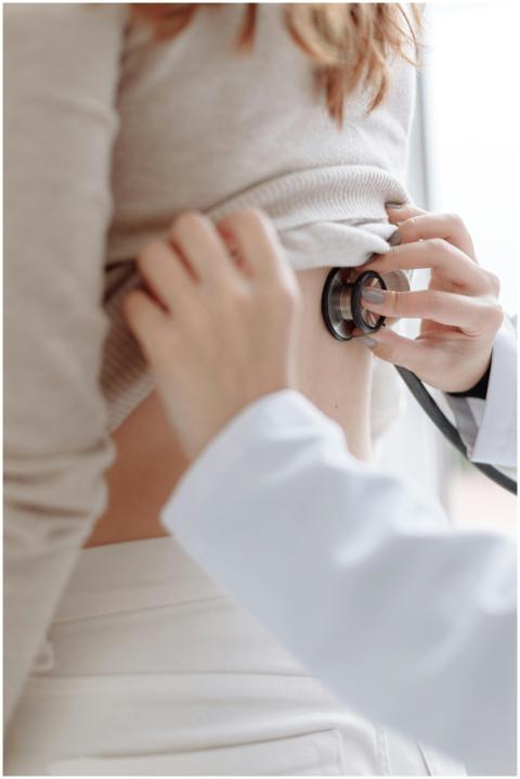 Close-up of doctor using stethoscope on patient's
