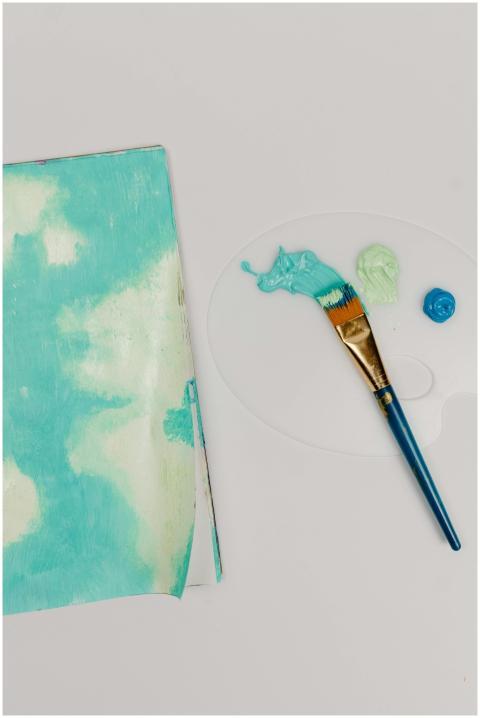 Creative flat lay of paintbrush and palette with p