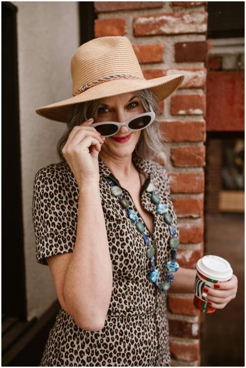 Elegant woman in leopard dress with hat and sungla