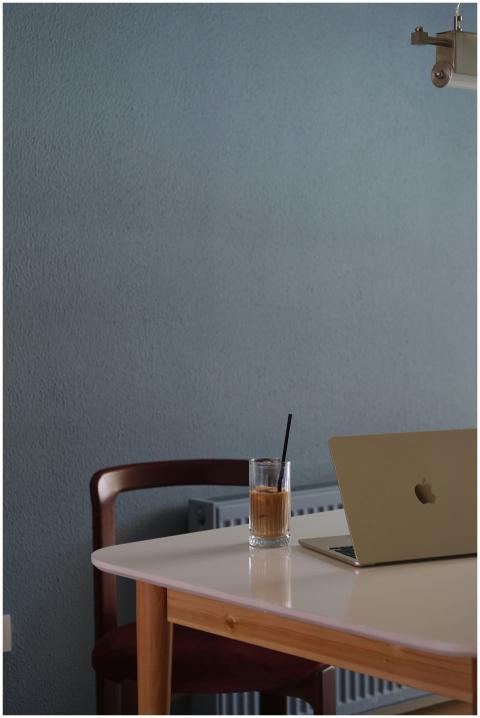 Simple and serene workspace with a laptop and iced