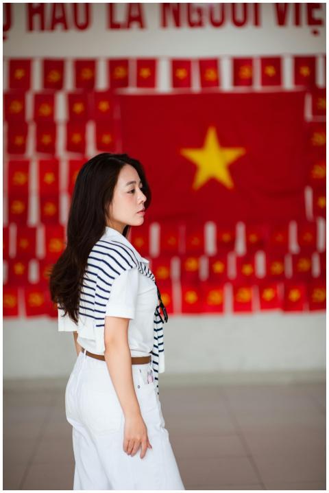 A young woman stands indoors in Hanoi, Vietnam, in