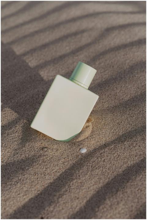 Elegant minimalist perfume bottle set against text