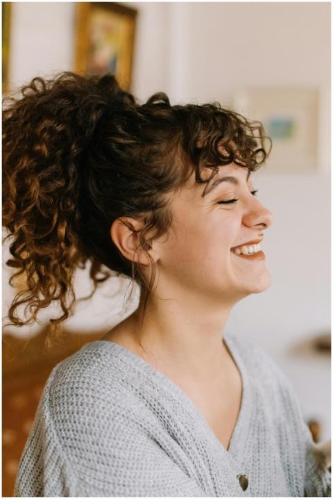 Portrait of a cheerful woman with curly hair smili