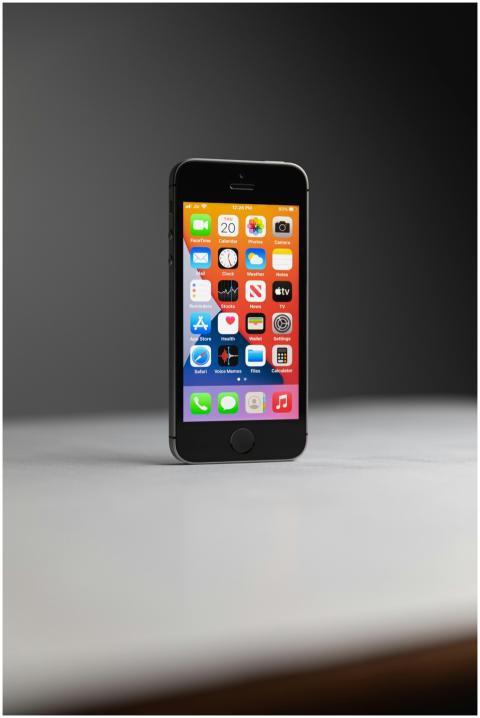 Close-up of a black smartphone displaying various