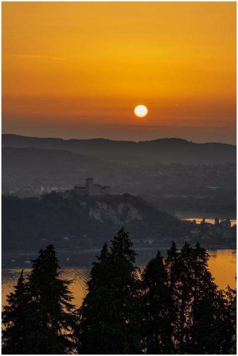 A tranquil sunset scene featuring a silhouette of