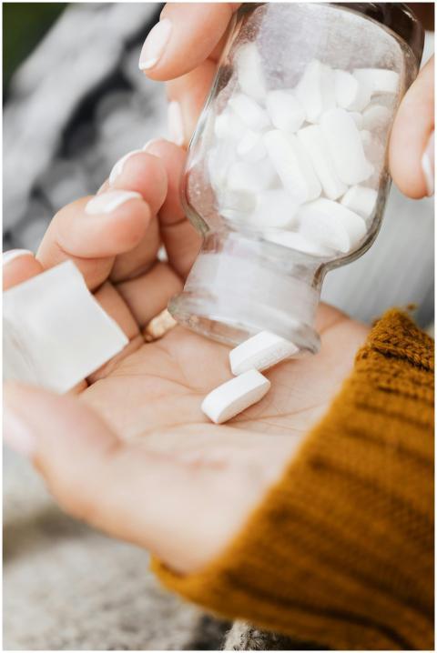 A close-up image of pills being poured into a hand