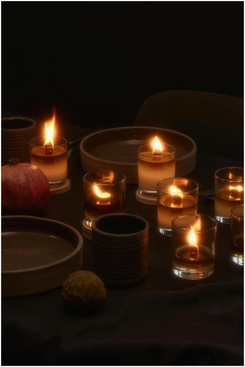 High angle of flaming candles placed near dishes a