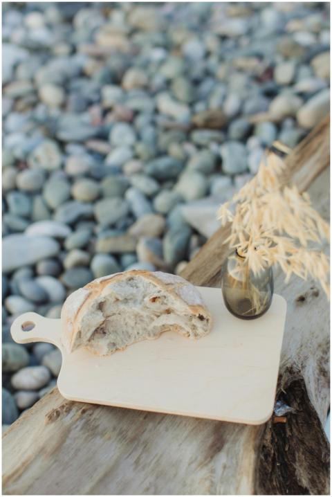 A rustic setting with fresh bread on a wooden boar