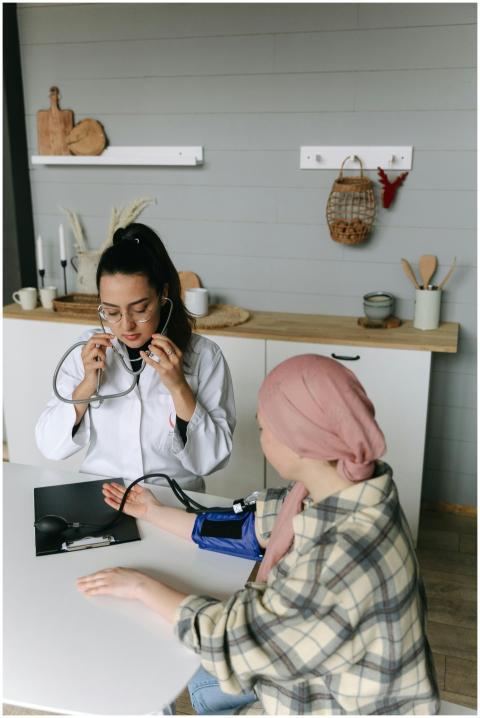 A doctor checks a patient's blood pressure in a me