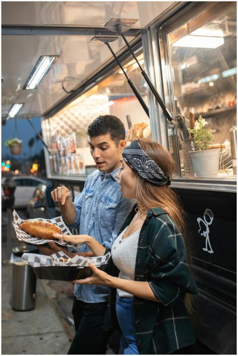 A young couple savoring delicious street food at a