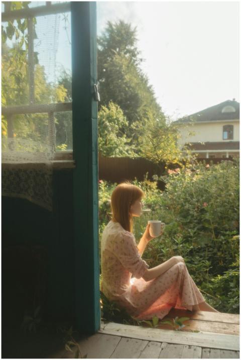 Woman enjoying morning coffee in a rustic outdoor