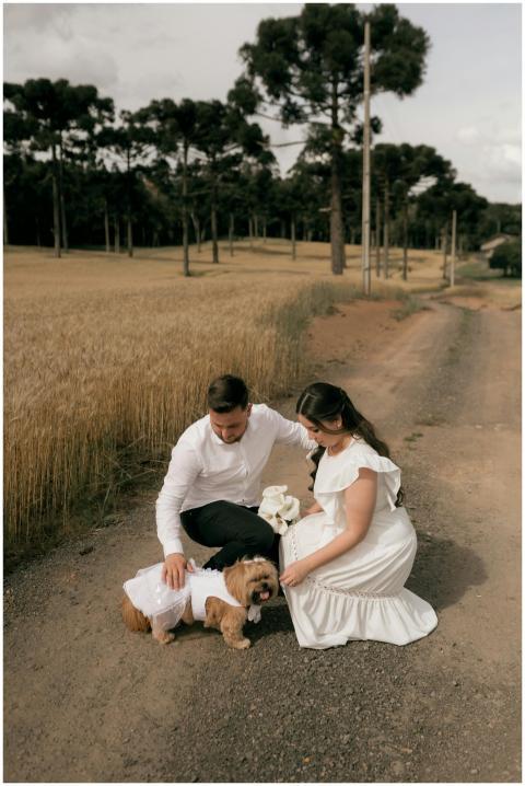 Romantic moment of a couple with a dog in the coun