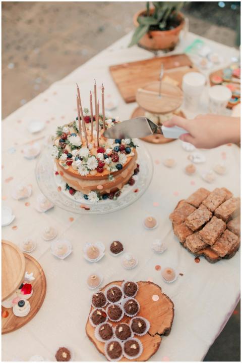 A rustic celebration setup with a layered cake and