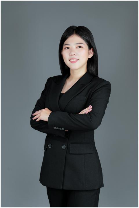Studio shot of a woman in a black suit posing conf