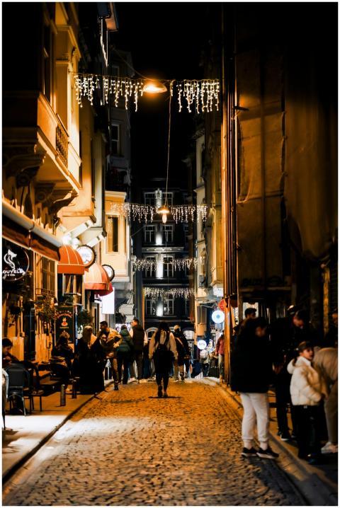 Vibrant night street scene with people walking on