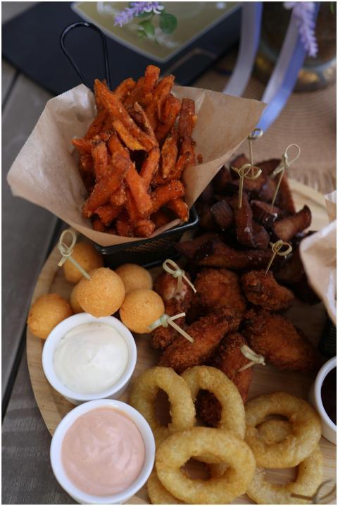 Indulgent snack platter featuring fries, onion rin