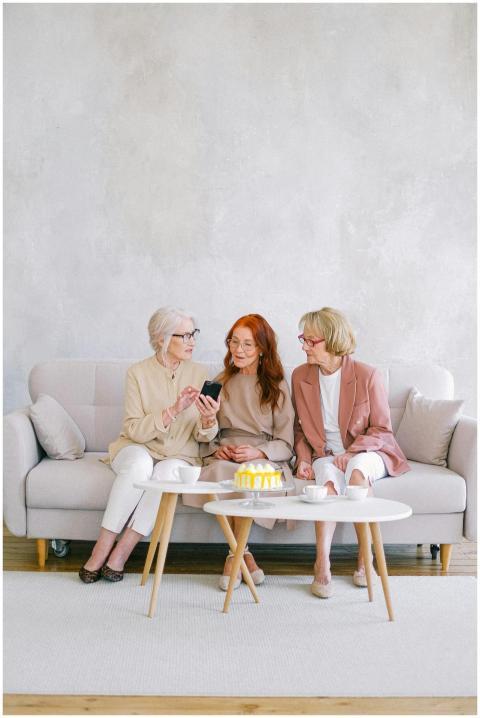 Three senior women enjoying tea and conversation i