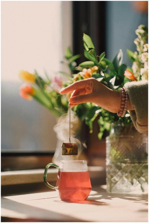 A peaceful scene of tea brewing near a window with