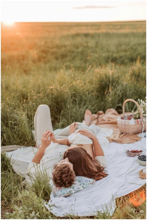 Couple enjoying a serene sunset picnic in a lush g