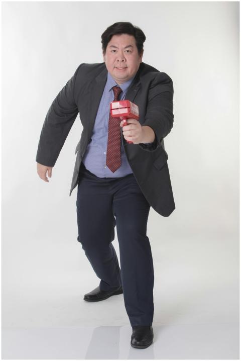 Asian businessman energetically holding a micropho