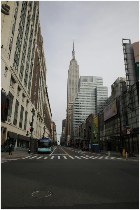A quiet New York City street with the Empire State