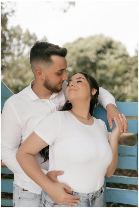 A couple embracing lovingly in a sunny outdoor set