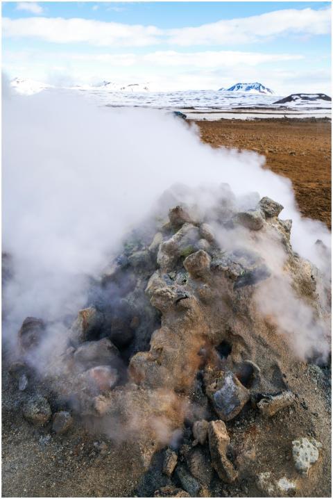 Geothermal steam rising from rocks in a snowy Icel