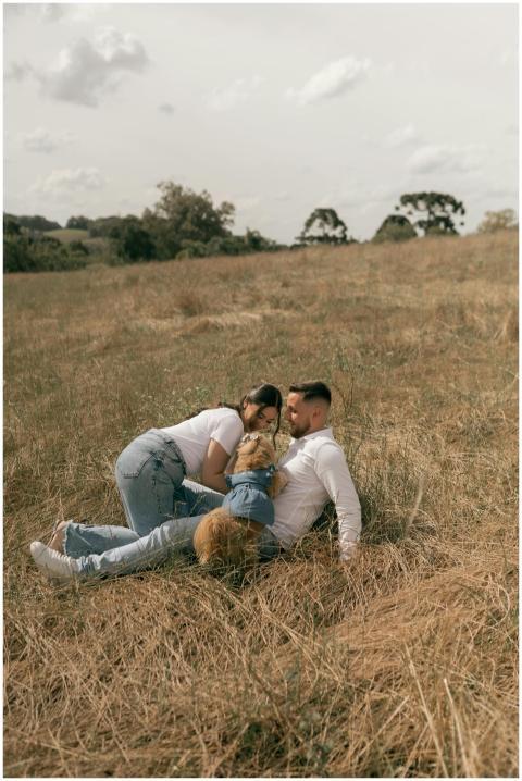 A couple enjoys a tranquil moment in a sunny field