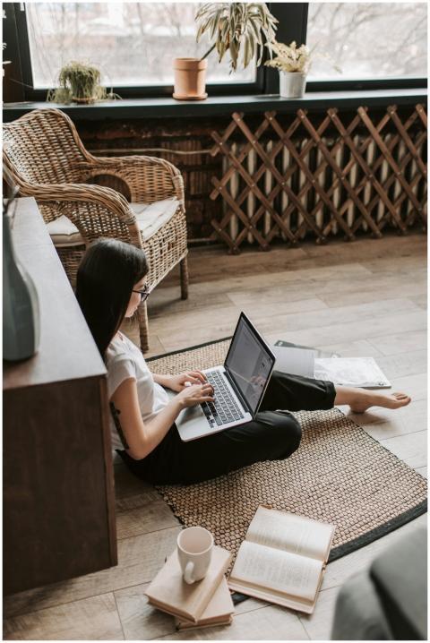 A young woman in casual attire working from home u