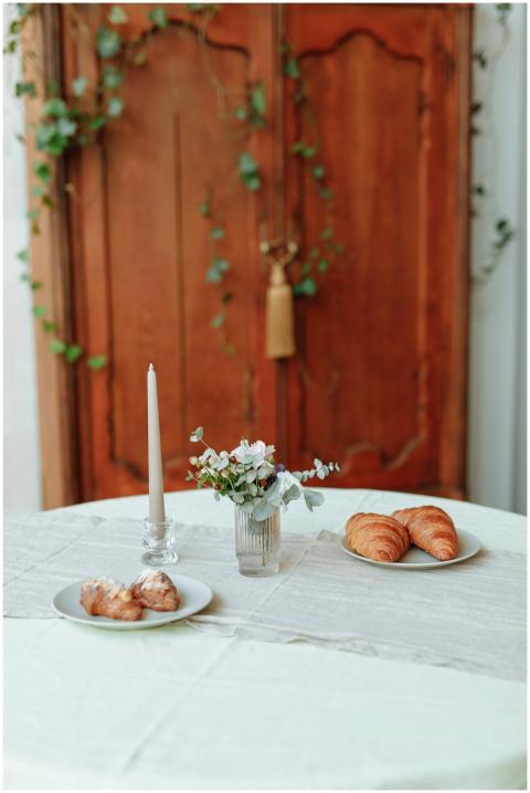 A stylish table setting featuring croissants, past