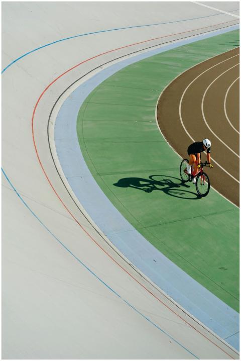 Cyclist wearing helmet races on a colorful outdoor