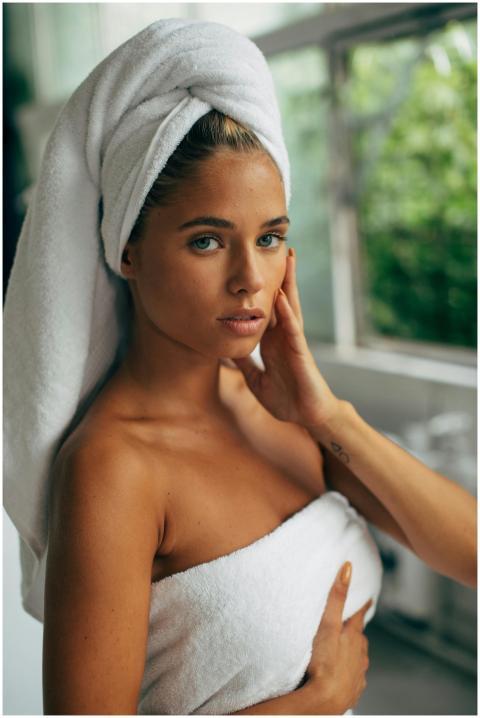 Portrait of a woman wrapped in a towel, enjoying n