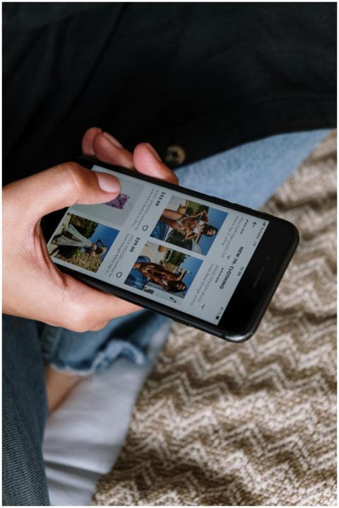 Close-up of a person browsing a fashion app on a s