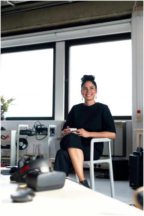 Confident young professional woman enjoying a coff