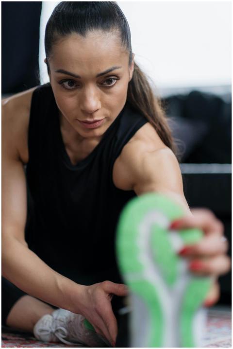Woman engaging in a stretching exercise at a fitne